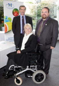 arried couple and a suited gentleman at an awards event