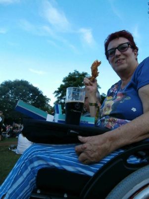 Lady using a trabasack at the Cambridge festival for fish and chips and a glass of Guinness