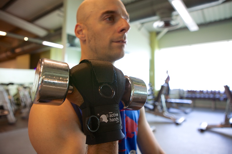 Rob Smith using general-purpose gripping aid to hold weight in gym