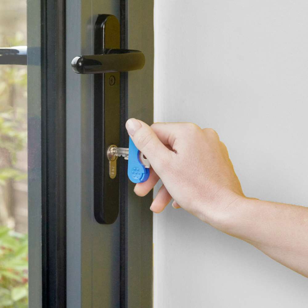 key with Keywing being used to unlock a door
