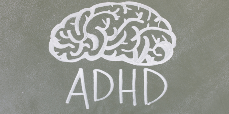 A drawing of a brain on a board with the letters ADHD in capitals underneath it