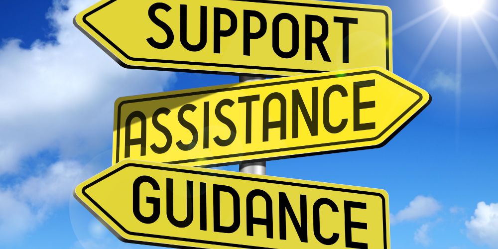 Support, Assistance, Guidance signpost with each word on a yellow background in black capital letters