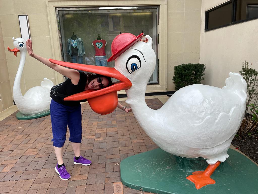 Mel with her head in a giant stork statue in Kansas City