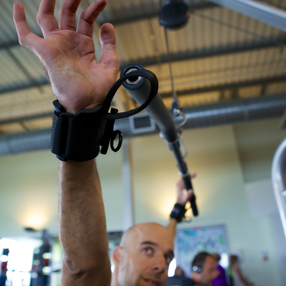 Looped gripping aids on bar. Adaptive gym equipment. Suitable for reduced hand function: tetra, quad, cerebral palsy, SCI, spinal cord injury, limb difference, stroke and more.