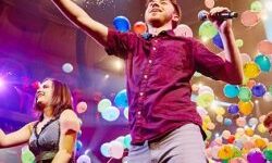 Music for Youth performing with lots of balloons on stage
