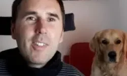 Martyn Sibley with his dog Sunny on a chair behind him