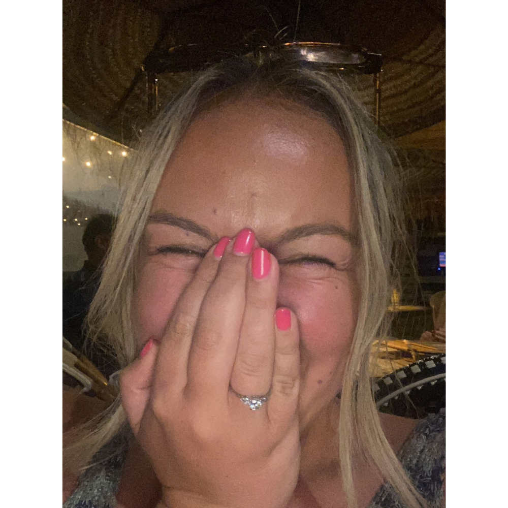 Millie, our marketing assistant, looking happy with her engagement ring