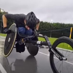 Rob wheelchair racing in the wet with his hard racing gloves