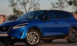 Blue Nissan Qashqai parked outdoors, viewed from the front and side.