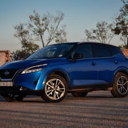 Blue Nissan Qashqai parked outdoors, viewed from the front and side.