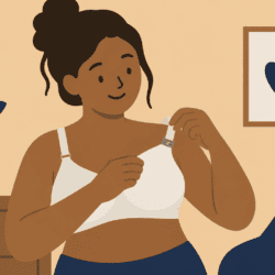 Disabled woman using one hand to adjust the clip on an adaptive nursing bra.
